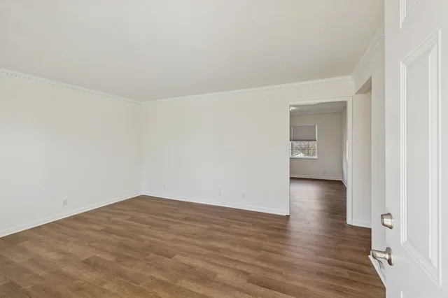 a view of a room with wooden floor