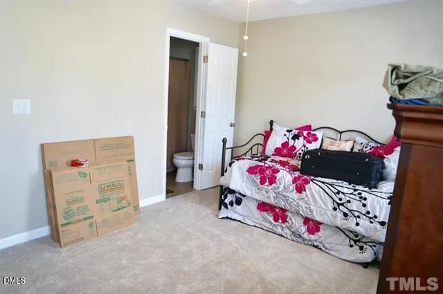 a bedroom with a bed and a dresser in it