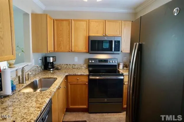 a kitchen with a sink stove and refrigerator