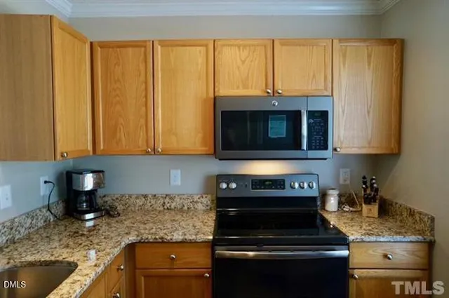 a kitchen with a sink and a stove top oven