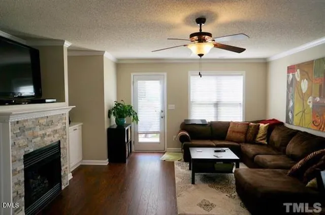 a living room with furniture a fireplace and a flat screen tv
