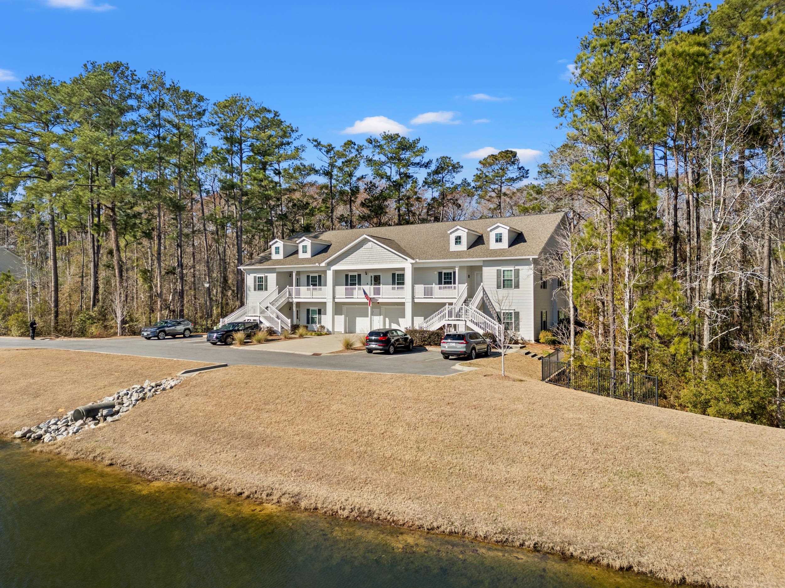 900 Jackline Place, Unit 202 Murrells Inlet, SC 29576 - Photo 15 of 39 Rear view of property with stairs, view of wooded area, and a water view