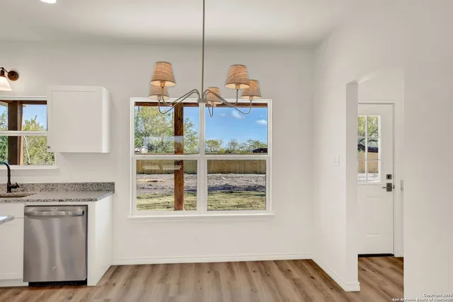 a view of dining room with wooden floor and window