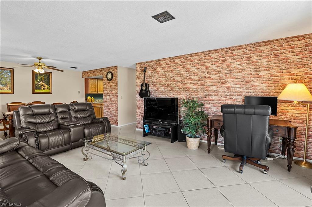 131 Teryl Road, Unit C3 Naples, FL 34112 - Photo 6 of 26 a living room with furniture and a flat screen tv