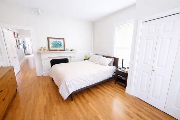 a bedroom with a bed and a painting on the wall