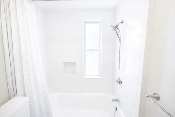 a bathroom with a bathtub and shower