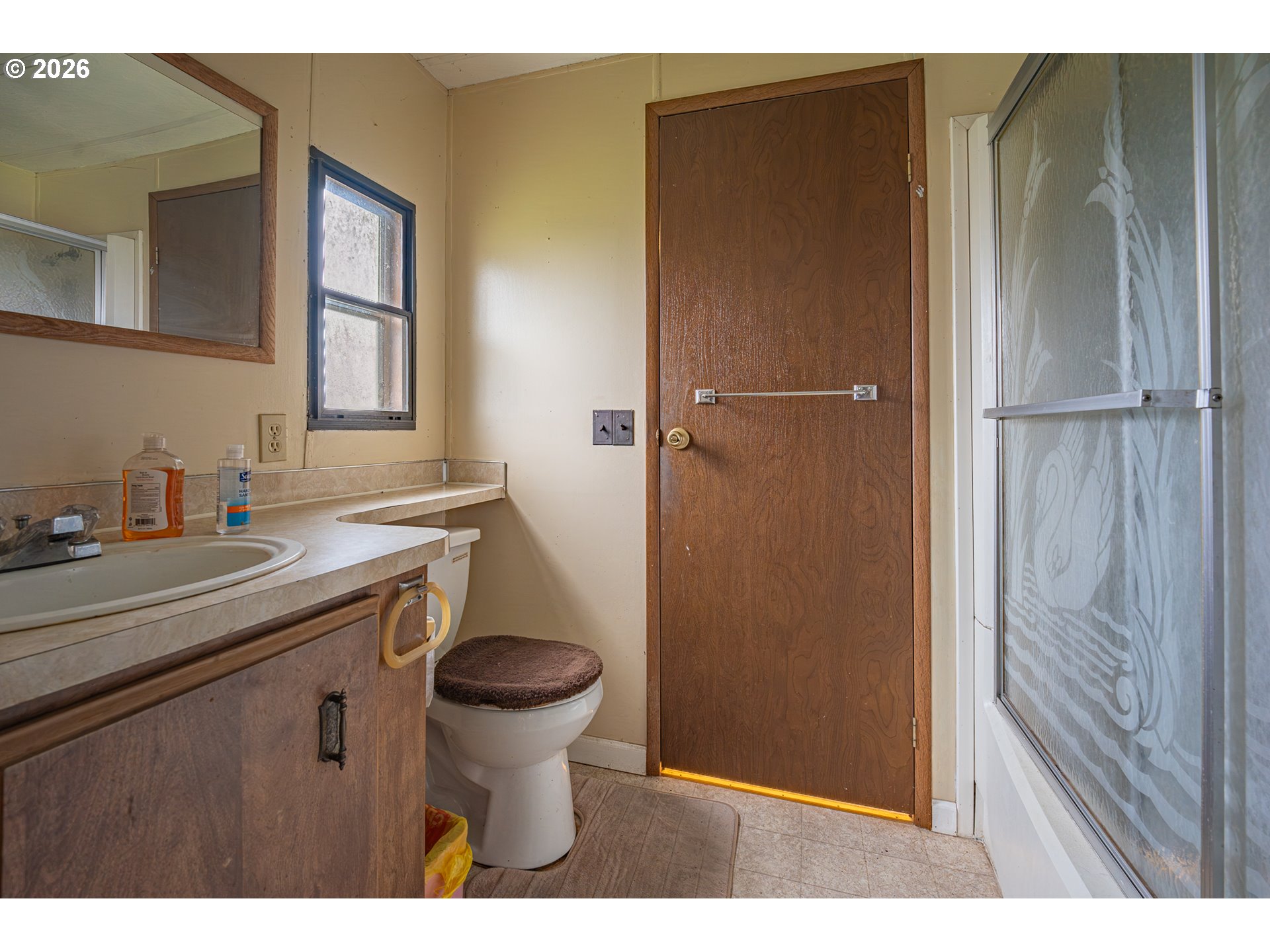 3393 Snow Peak Place Lebanon, OR 97355 - Photo 2 of 13 a bathroom with a sink a toilet a mirror and shower
