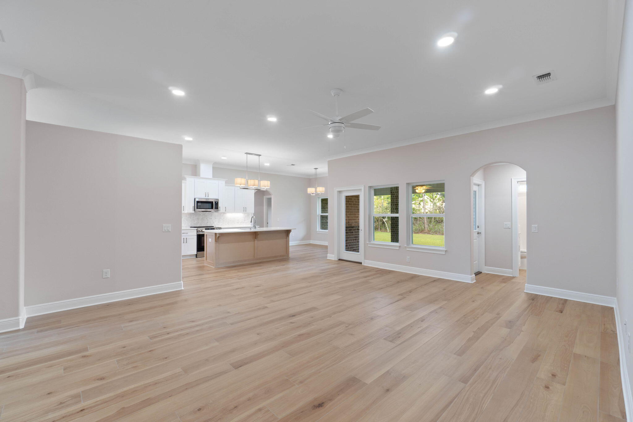 6752 Redfield Street Navarre, FL 32566 - Photo 10 of 64 a view of an empty room with wooden floor and a window