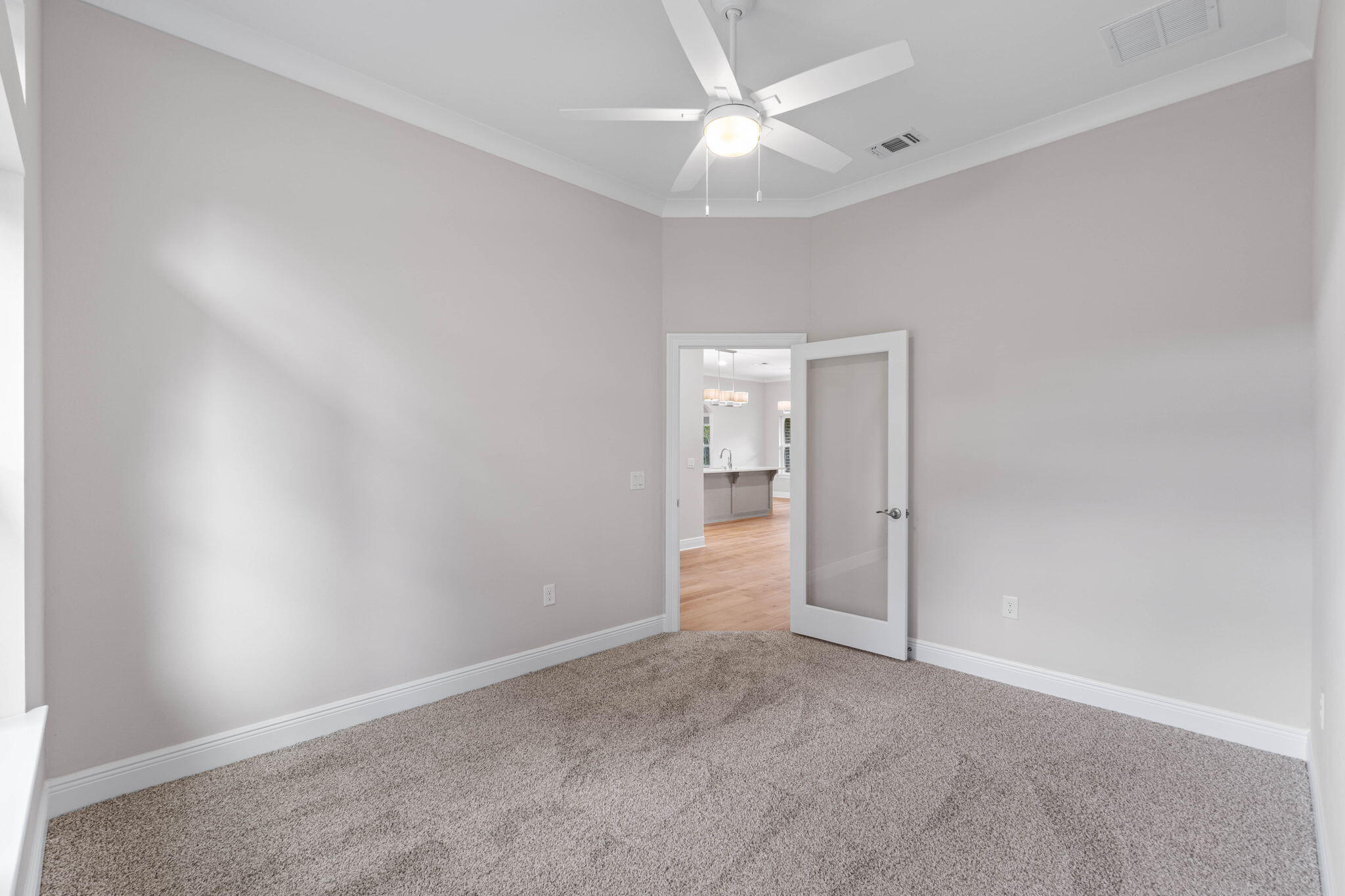 6752 Redfield Street Navarre, FL 32566 - Photo 19 of 64 an empty room with a ceiling fan and carpet