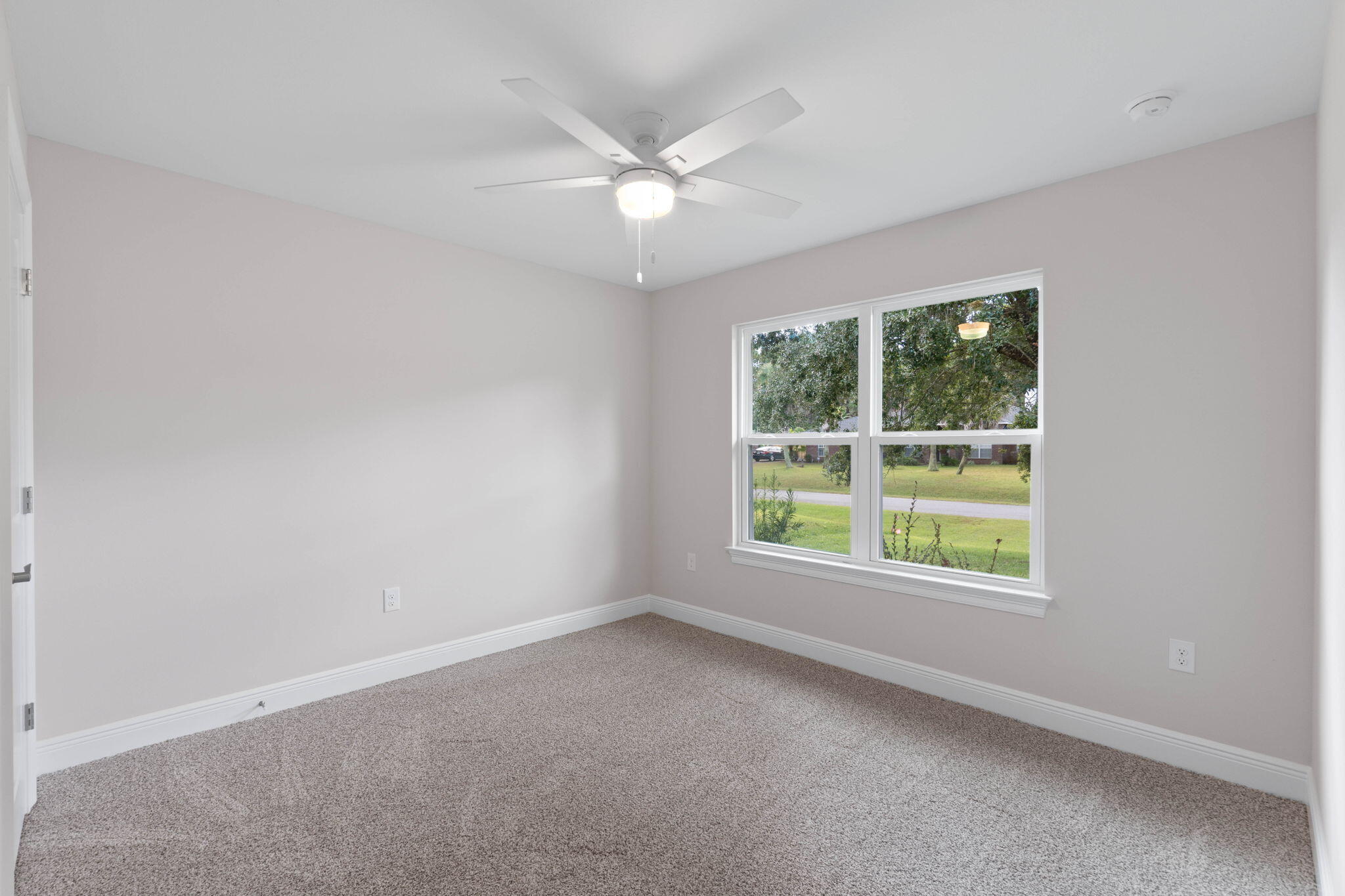 6752 Redfield Street Navarre, FL 32566 - Photo 30 of 64 an empty room with windows and fan