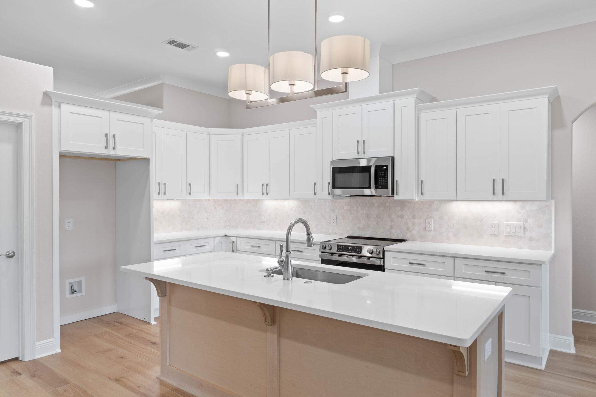 6752 Redfield Street Navarre, FL 32566 - Photo 7 of 64 a kitchen with a sink a microwave and cabinets