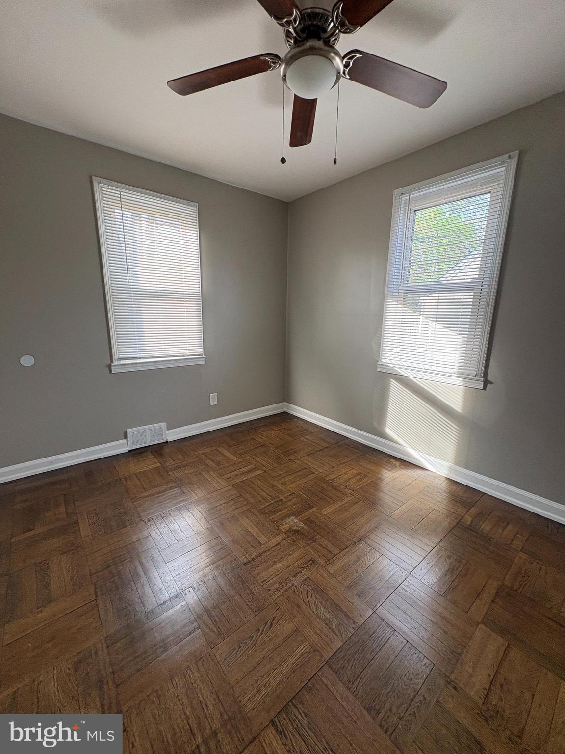 228 Phillips Avenue Runnemede, NJ 08078 - Photo 5 of 6 an empty room with wooden floor and windows