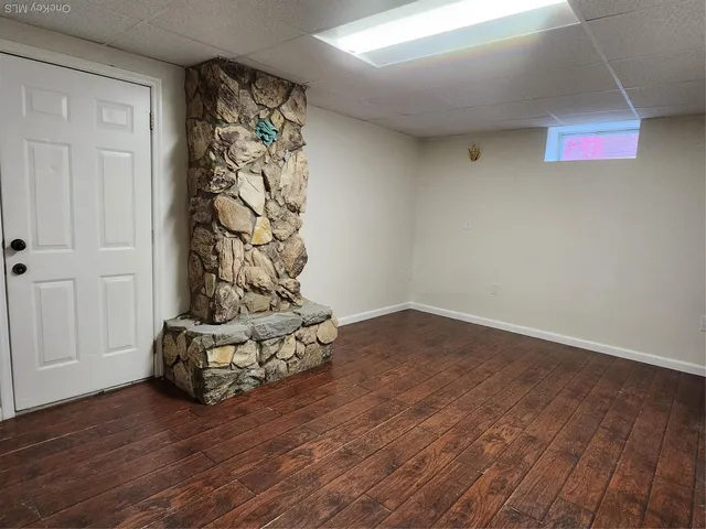 a view of a livingroom with wooden floor and a window