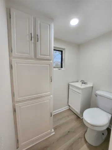 a white toilet sitting next to a bathroom sink