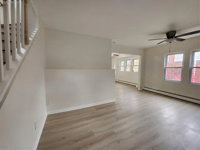 wooden floor in an empty room with a window