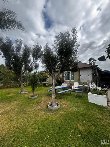 a couple of flower plants in front of building