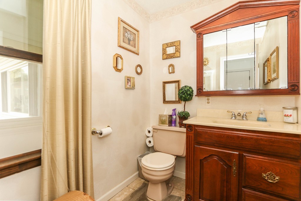 1016 Frank Smith Road Longmeadow, MA 01106 - Photo 18 of 28 a bathroom with a toilet a sink and a window