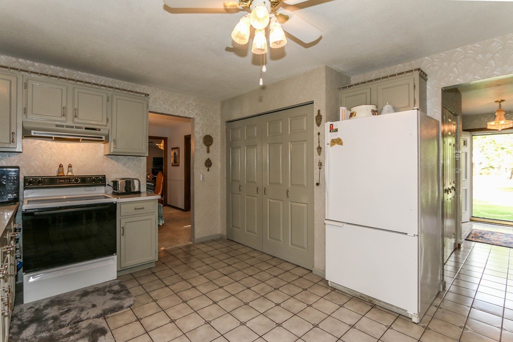 1016 Frank Smith Road Longmeadow, MA 01106 - Photo 9 of 28 a kitchen with a refrigerator a stove top oven and cabinets