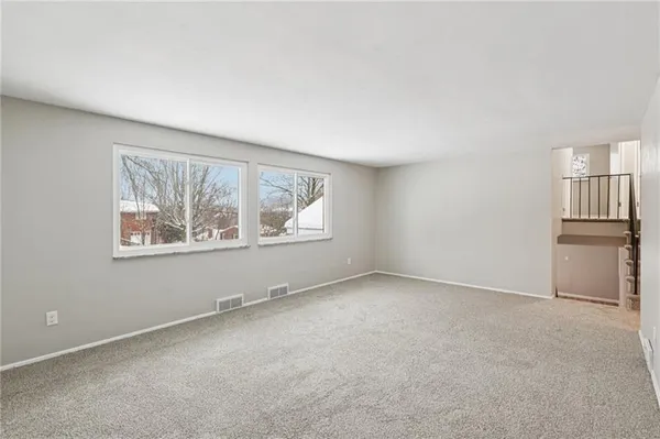 an empty room with windows and closet