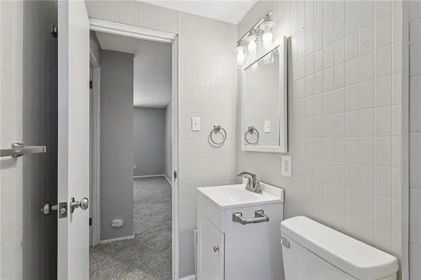 a bathroom with a toilet sink shower and mirror