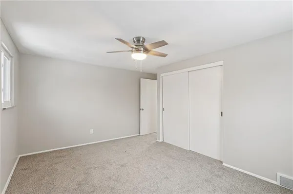 a view of a room with a ceiling fan and a chandelier fan