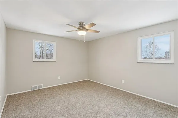 a view of an empty room with a fan