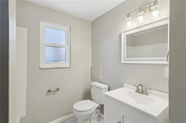 a white toilet sitting next to a bathroom sink