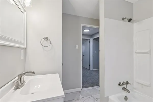 a bathroom with a sink and shower