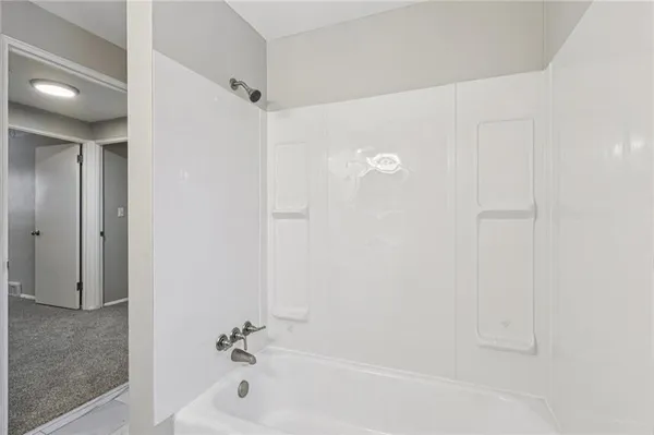 a bathroom with a tub and shower