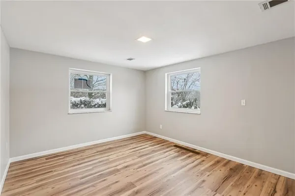 a view of a room with wooden floor and window