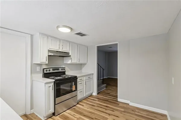 a kitchen with stainless steel appliances a stove and a refrigerator