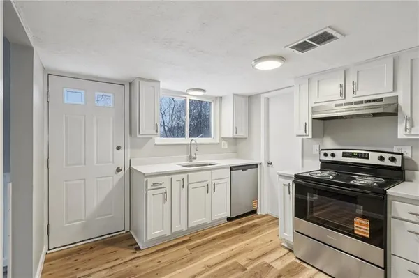 a kitchen with cabinets and stainless steel appliances