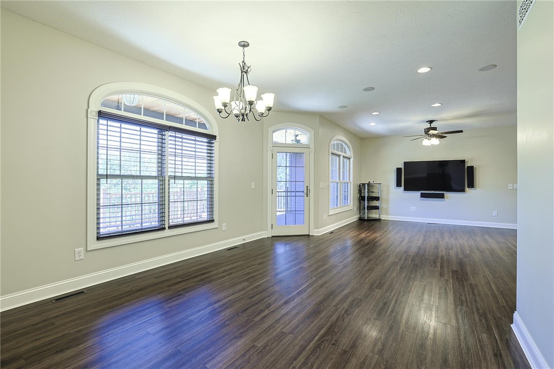 3681 Wilmington Road Lebanon, OH 45036 - Photo 10 of 87 This expansive living area features elegant flooring and abundant natural light through arched windows and a glass door.