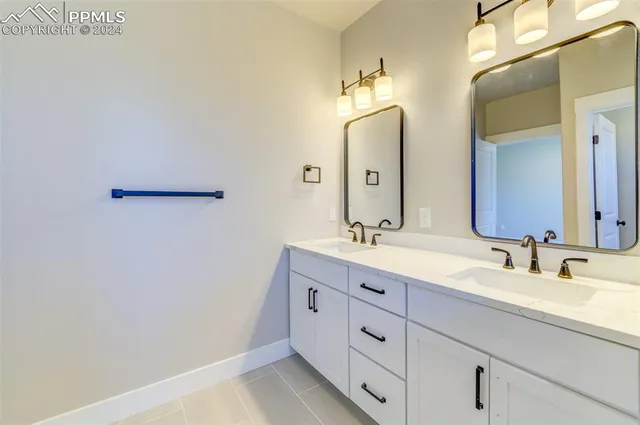a bathroom with a double vanity sink and a mirror