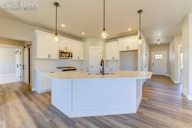 a large kitchen with stainless steel appliances kitchen island a large island in the center