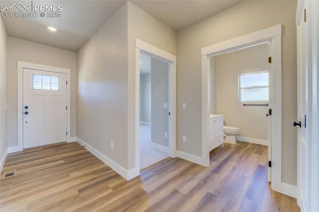 a view of a room with wooden floor and a bathroom