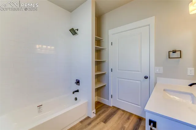 a bathroom with a bathtub and shower