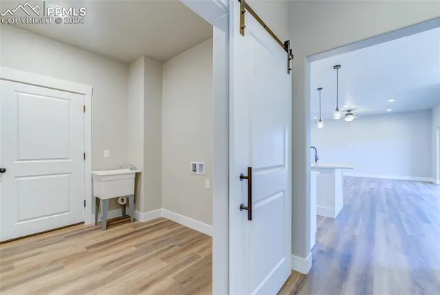 a view of a room with wooden floor and white walls