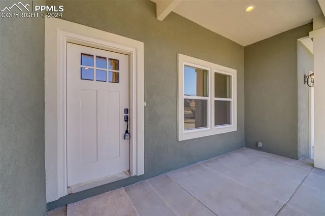 a view of an empty room with windows