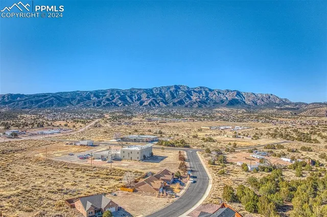a view of a large mountain with mountains in the background