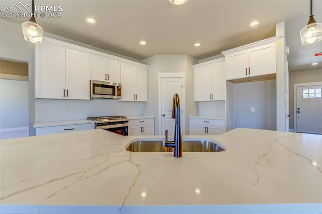 a kitchen with a sink a stove and refrigerator