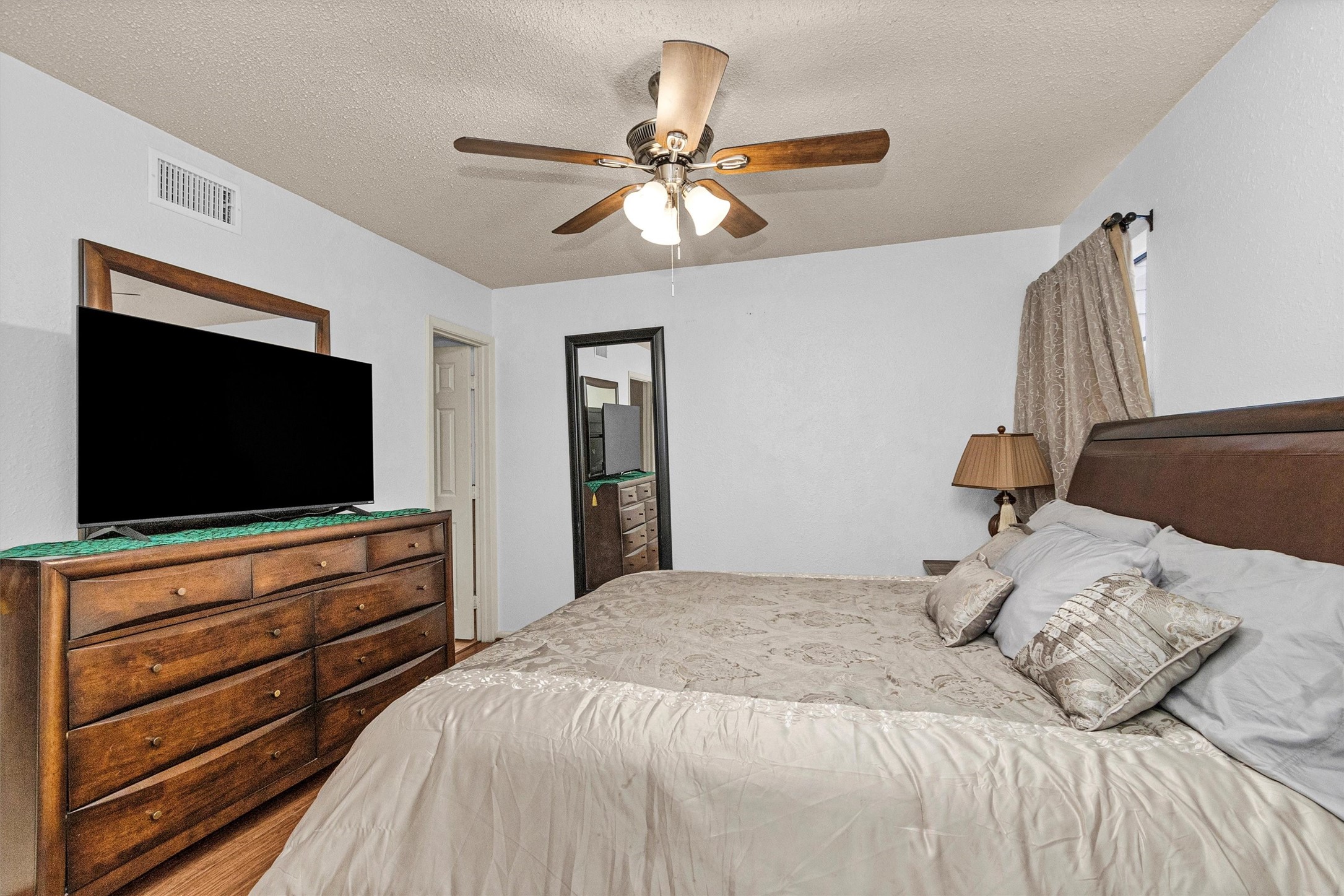 12900 Walden Road, Unit 411 Montgomery, TX 77356 - Photo 13 of 18 a bedroom with a bed and a flat screen tv