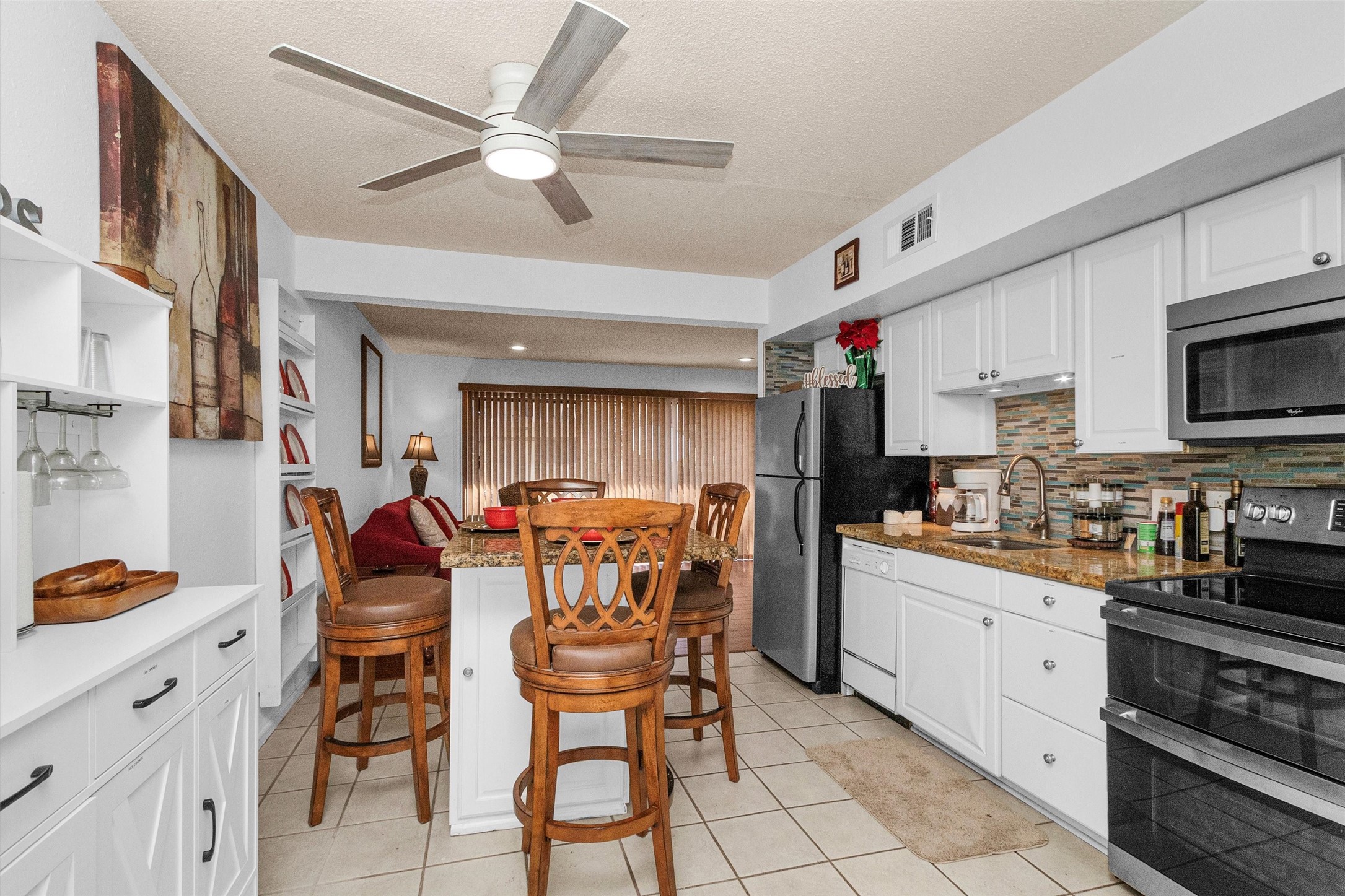 12900 Walden Road, Unit 411 Montgomery, TX 77356 - Photo 3 of 18 a kitchen with stainless steel appliances kitchen island granite countertop a sink and cabinets