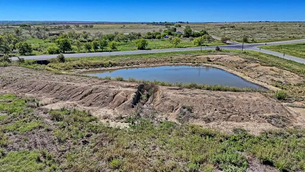 an aerial view of a houses with a yard