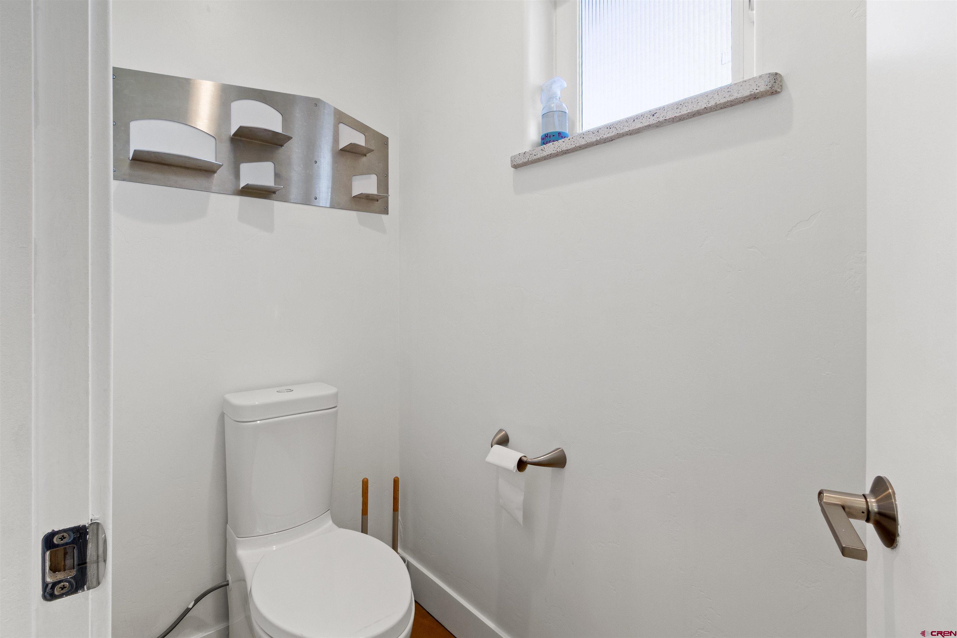 2192 Odelle Road Montrose, CO 81401 - Photo 16 of 45 a white toilet sitting next to a bathroom sink