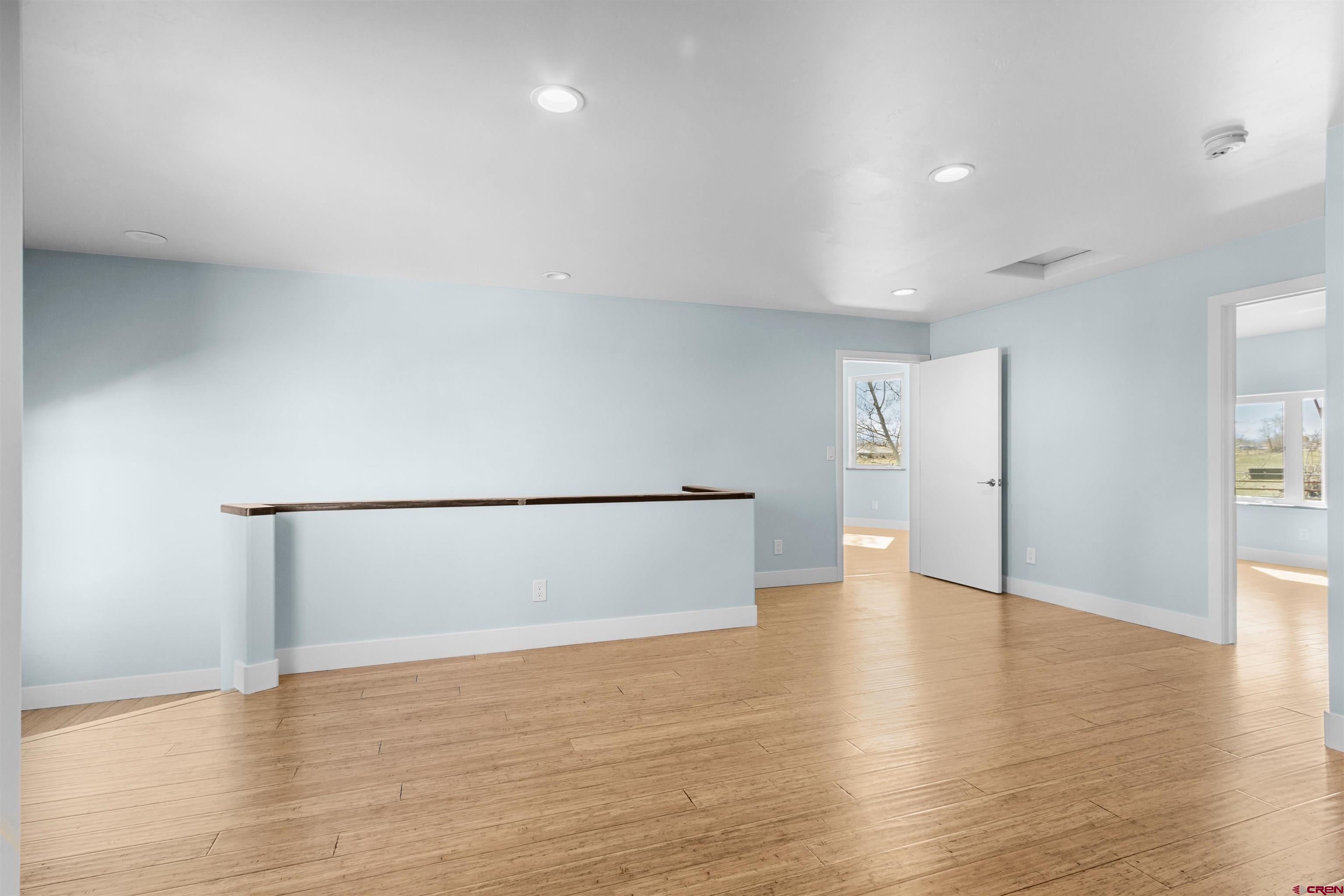 2192 Odelle Road Montrose, CO 81401 - Photo 22 of 45 a view of an empty room with wooden floor
