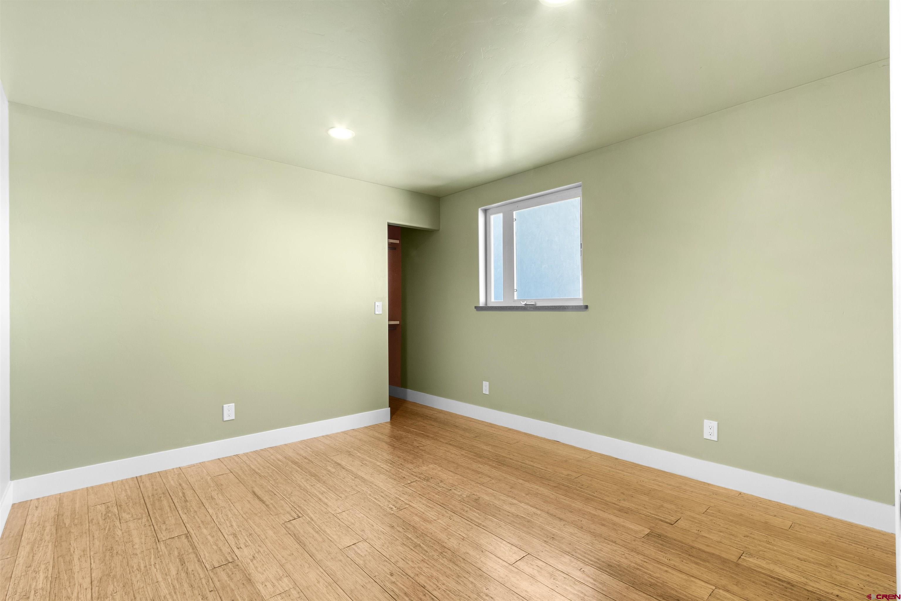 2192 Odelle Road Montrose, CO 81401 - Photo 23 of 45 an empty room with wooden floor and windows