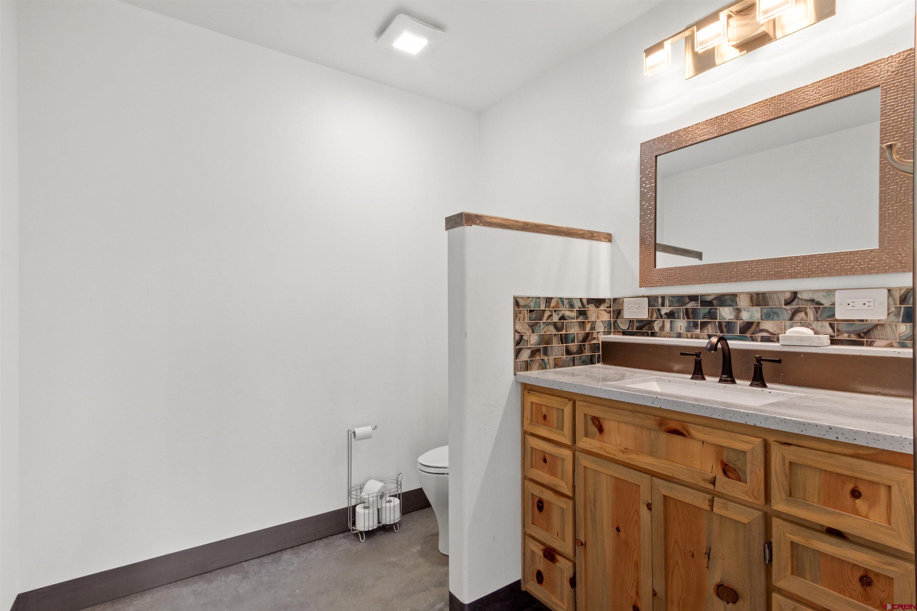 2192 Odelle Road Montrose, CO 81401 - Photo 35 of 45 a bathroom with a granite countertop sink and a mirror