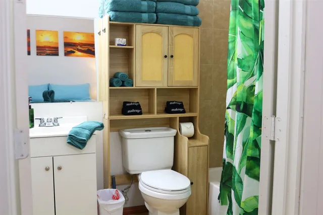 a bathroom with a toilet a sink and garden view