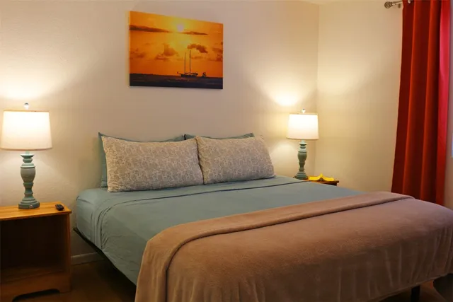 a bedroom with a bed and lamp